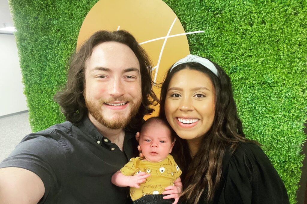 Brady Sticker with his wife and child outdoors